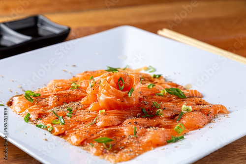 Plate of Salmon Carpaccio on the table.