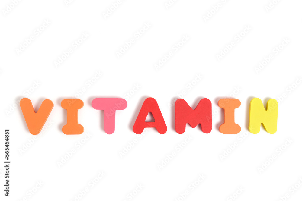 Word vitamin is laid out letters white background. Word vitamin is laid out letters white background.