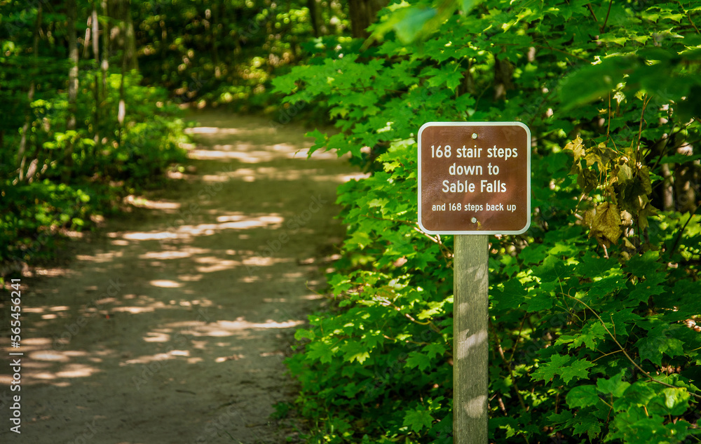 Funny Sign for distance to Sable falls attraction on Woods Trail Head Northern Michigan Park