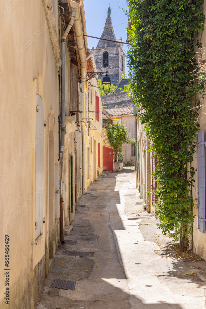 Steeple on a small church seen through an alley in Arles.