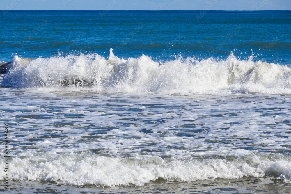 Striking scene of waves breaking on the sand of a Spanish beach	
