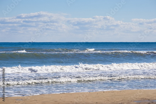 Striking scene of waves breaking on the sand of a Spanish beach 