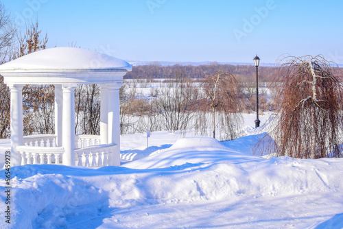 Bild auf Leinwand gazebo in the snow-covered park of the noble estate