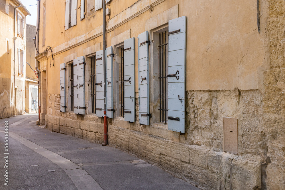 Windows with wooden shutters along a narrow street. Windows with wooden shutters along a narrow street.
