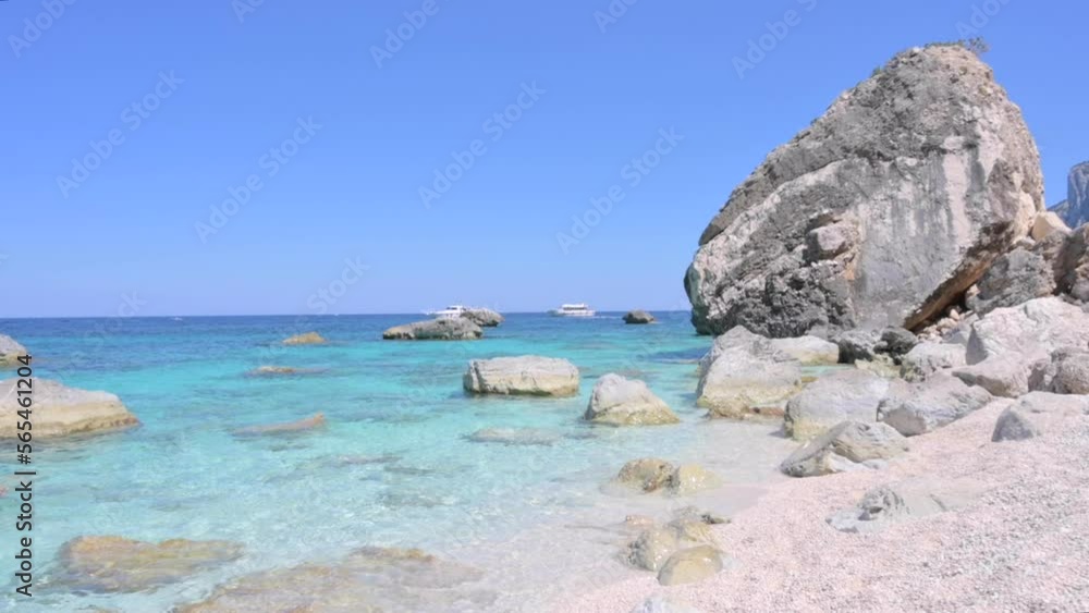Blue beach in Sardinia. Italian coast, elite resorts. BLUE SKY AND CLEAR WATER and white small stones. High quality 4k footage. Vertical Blue beach in Sardinia. Italian coast, elite resorts. BLUE SKY AND CLEAR WATER and white small stones. High quality 4k footage. Vertical