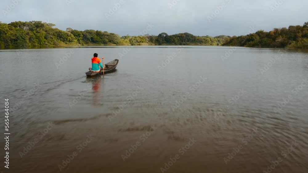 aerial drone view of a man paddling a canoe on a mighty river inside the jungle of guaviare in colombia 4k aerial drone view of a man paddling a canoe on a mighty river inside the jungle of guaviare in colombia 4k