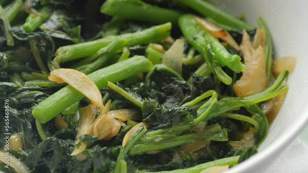 Top view of bowl with cooked spinach on table Top view of bowl with cooked spinach on table