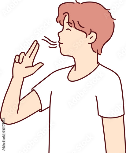 Casual guy teenager puts fingers to lips depicting gun and lights invisible cigarette. Vector image