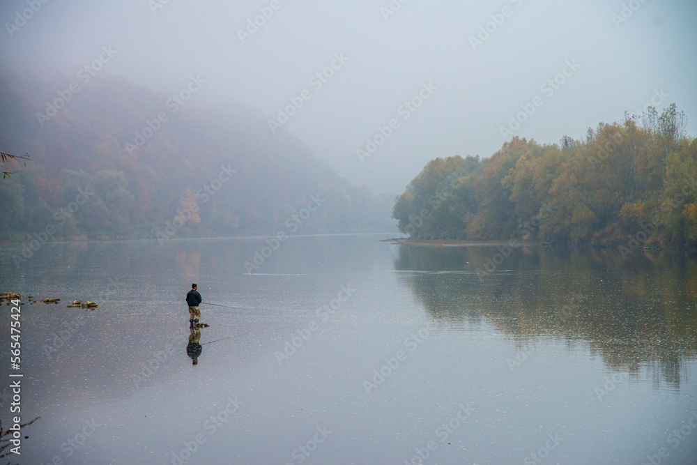 Fishing on the autumn river in the water Fishing on the autumn river in the water