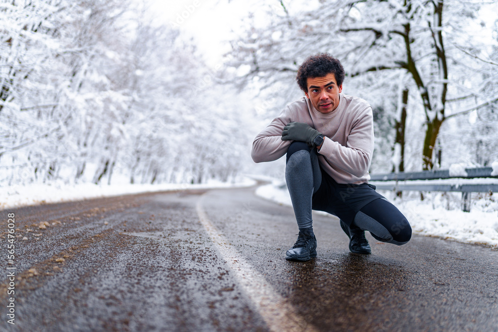 Man looking at his phone and sending text massages, there's snow covered scenery in the background Man looking at his phone and sending text massages, there's snow covered scenery in the background