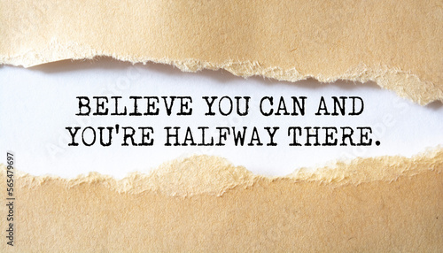 Believe You Can And You're Halfway There. Words written under torn paper. Motivation concept text.
