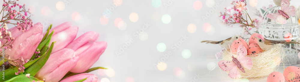 Easter background with colored Easter eggs and blooming flowers. Tulips. Easter composition. Easter. Banner. Copy space