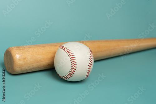 close up baseball and baseball bat on green table background, sport concept