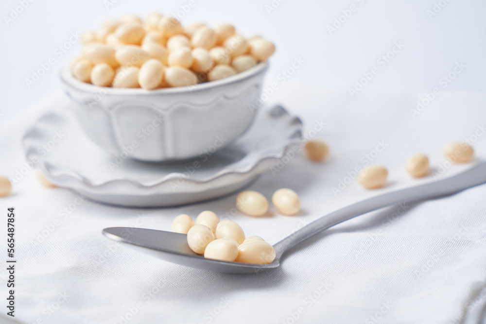 Probiotic and lactobacillus capsules in a bowl with a white background Probiotic and lactobacillus capsules in a bowl with a white background