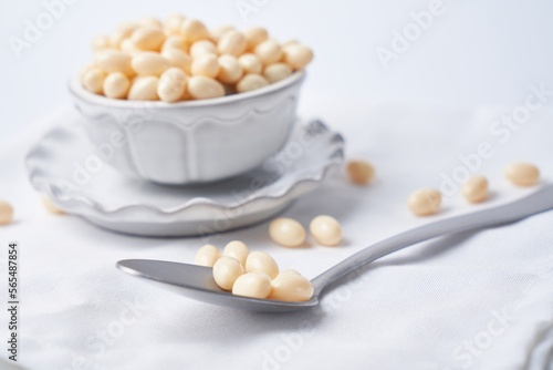 Probiotic and lactobacillus capsules in a bowl with a white background