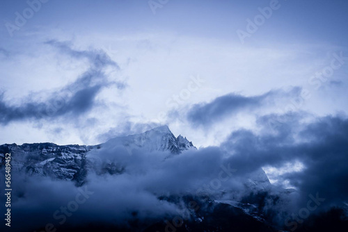Clouds blow across the Himalayan peaks at twilight
