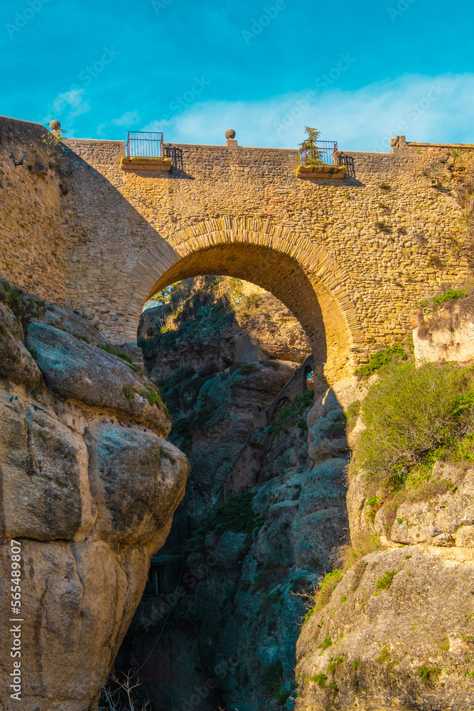 The Old Bridge (Puente Viejo) and the Ronda Gorge (Tajo de Ronda) on the Guadalevin River. Andalusia, province of Malaga, Spain
