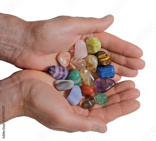 Male Crystal therapist with cupped hands filled with a selection of multicoloured healing tumbled gem stones transparent png file	