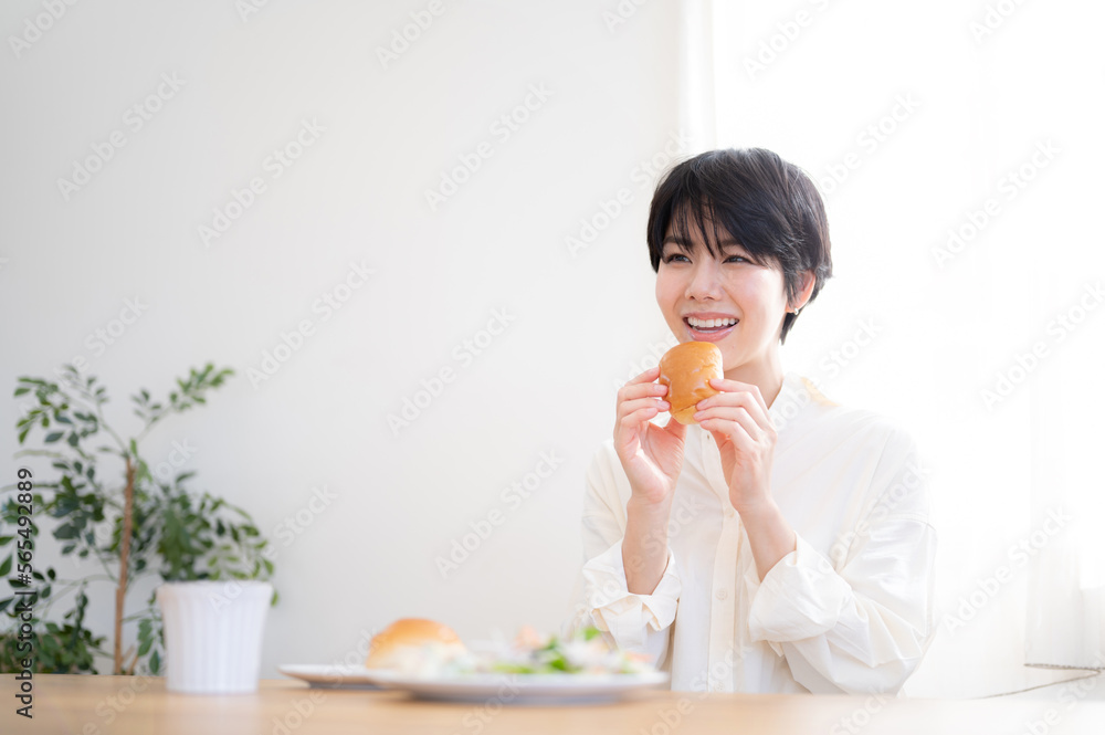 Asian woman eating bread A fresh breakfast scene with a beautiful morning sunrise Asian woman eating bread A fresh breakfast scene with a beautiful morning sunrise