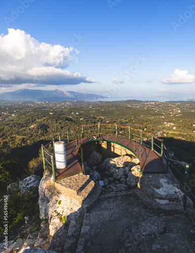 View of Kaiser's Throne observation deck lookout, Pelekas village, Corfu island, Greece, Kaiser William II summit Observatory panoramic summer view with mountains and Kerkyra in the background photo