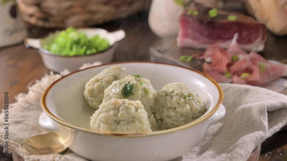 Canederli or Knodel in broth with green onion. North italian traditional dish, typical pasta for Trento, Alps, Alto Adige, Italian, Austrian cuisine. High quality 4k footage. Canederli or Knodel in broth with green onion. North italian traditional dish, typical pasta for Trento, Alps, Alto Adige, Italian, Austrian cuisine. High quality 4k footage.