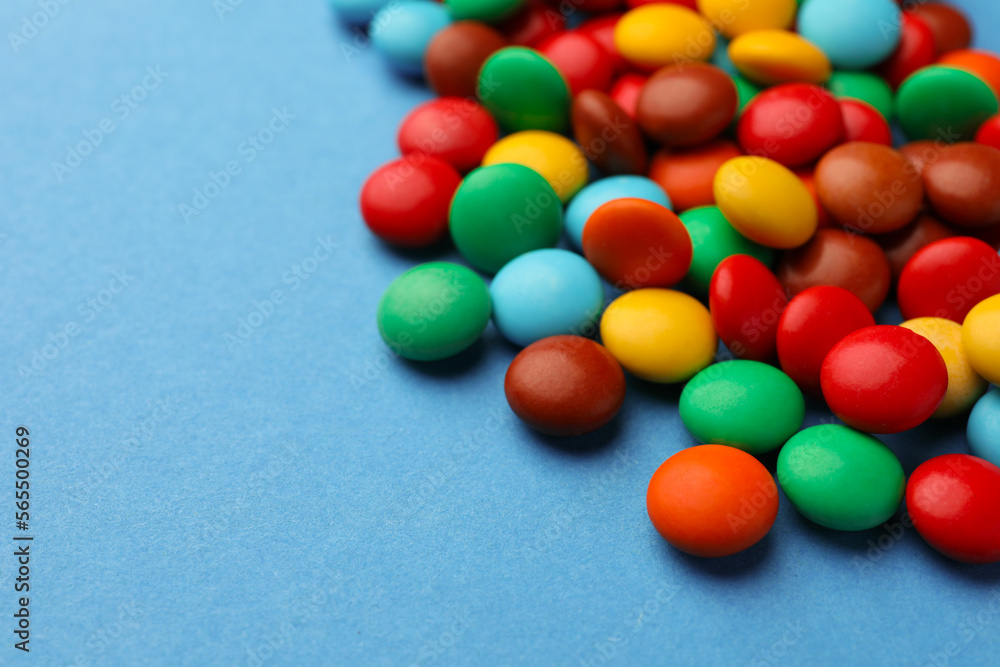 Tasty colorful candies on blue background, closeup. Space for text Tasty colorful candies on blue background, closeup. Space for text