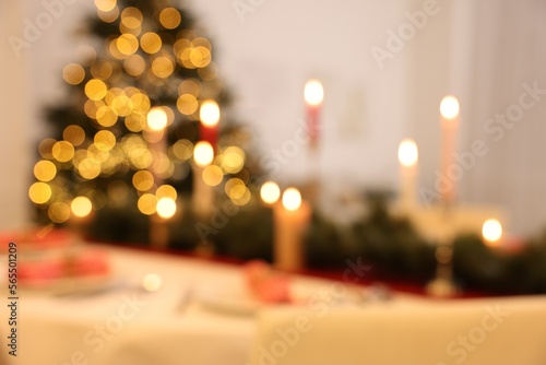 Blurred view of festive table setting and beautiful Christmas decor indoors. Interior design