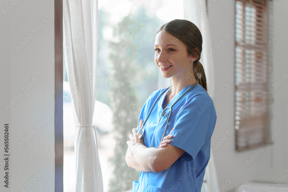 Portrait of beauty caucasian female nurse or caregivers worker in medical working dress standing, hands crossed, indoors. Portrait of beauty caucasian female nurse or caregivers worker in medical working dress standing, hands crossed, indoors.