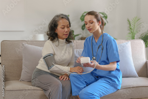 Female doctor taking a history of a patient and counseling on orthopedic diseases with female patients after measuring blood pressure and heart rate in a medical facility