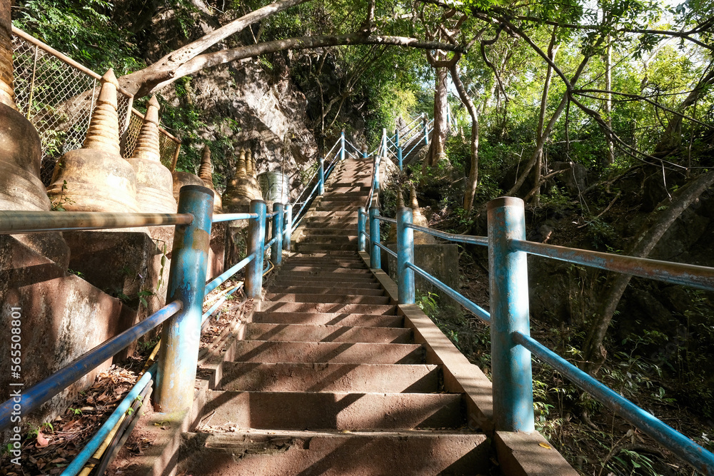Fototapeta premium Stairs to viewpoint in Tiger Cave Temple on sunny day. Krabi, Thailand.