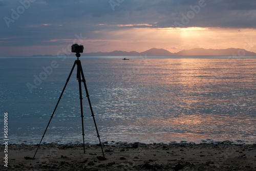 Camera on tripod on the beach at sunset. Klong Muang Beach, Krabi Province, Thailand.
