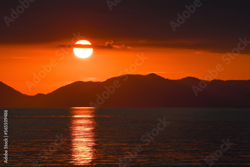 Sunset sky above the mountains and sea. View from Klong Muang Beach. Krabi Province  Thailand.