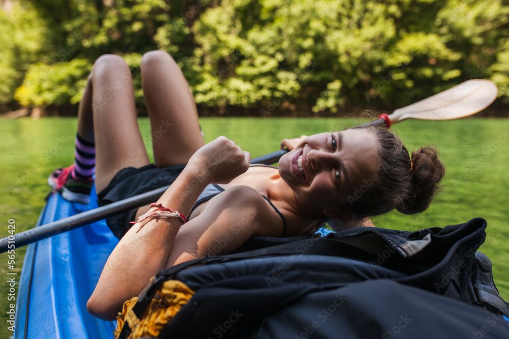 young active girl enjoying a kayak ride on a river in the mountains - obrazy, fototapety, plakaty 