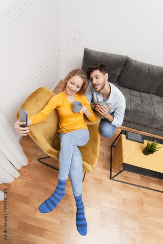 couple in love taking selfie smiling and having fun at home © Nikola Spasenoski