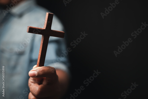 Priest holding bible book and crucifix Christian concept 