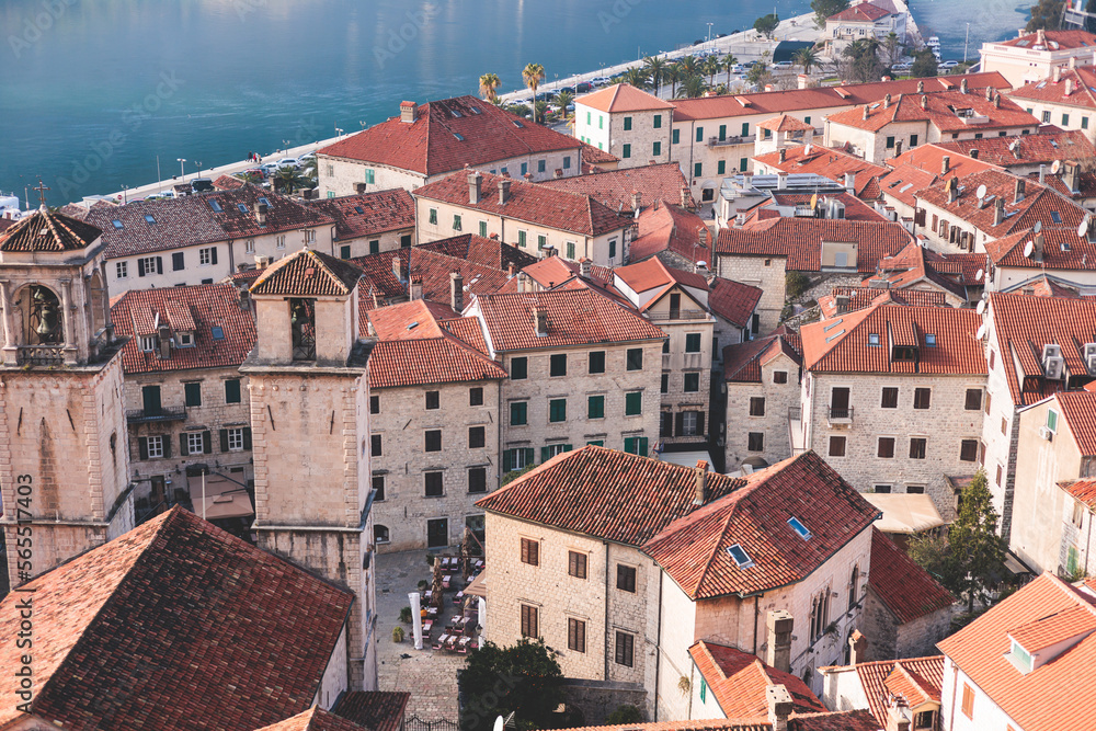 Fototapeta premium Kotor, Montenegro, beautiful top panoramic view of Kotor city old medieval town seen from San Giovanni St. John Fortress, with Adriatic sea, bay of Kotor and Dinaric Alps mountains in a sunny day