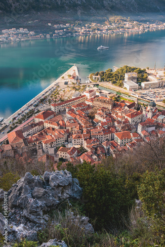 Kotor, Montenegro, beautiful top panoramic view of Kotor city old medieval town seen from San Giovanni St. John Fortress, with Adriatic sea, bay of Kotor and Dinaric Alps mountains in a sunny day