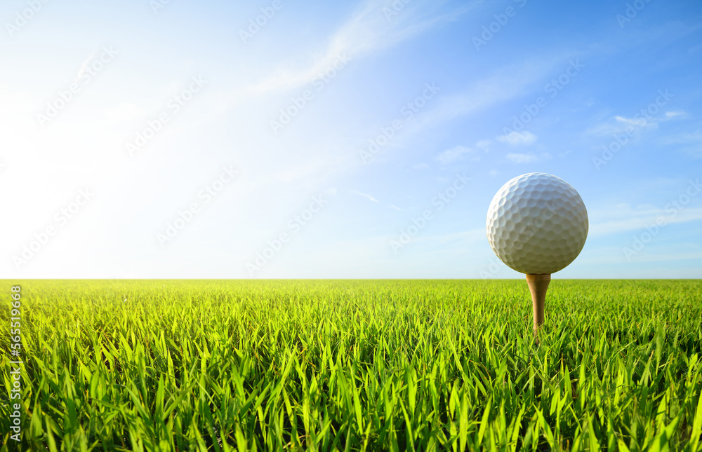 Golf ball on tee with blue sky background. Golf ball on tee with blue sky background.
