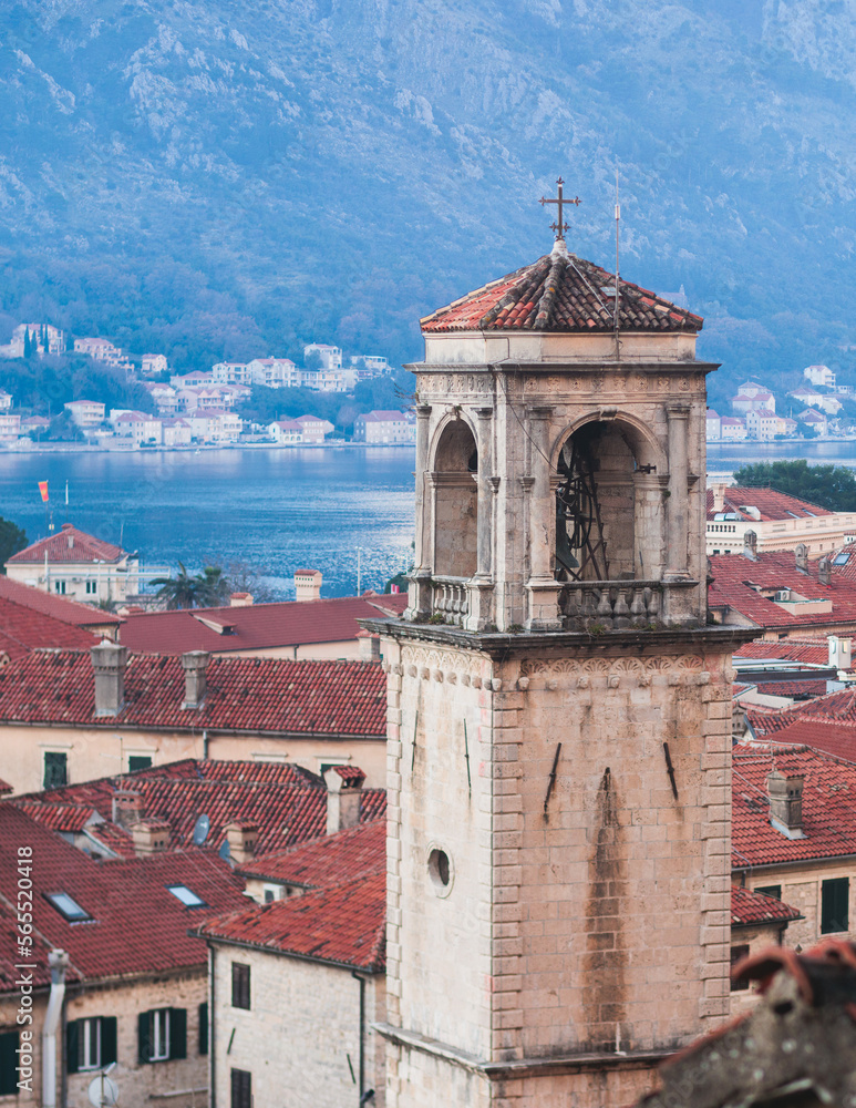 Fototapeta premium Kotor, Montenegro, beautiful top panoramic view of Kotor city old medieval town seen from San Giovanni St. John Fortress, with Adriatic sea, bay of Kotor and Dinaric Alps mountains in a sunny day