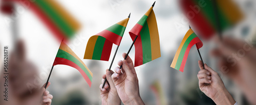 A group of people holding small flags of the Lithuania in their hands photo