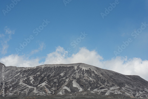 Mountain, Malang, Indonesia. The mountains are gray with a clear sky above