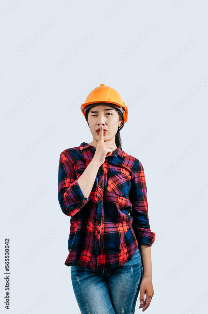Young female engineer wearing yellow helmet stand with charming smile posture