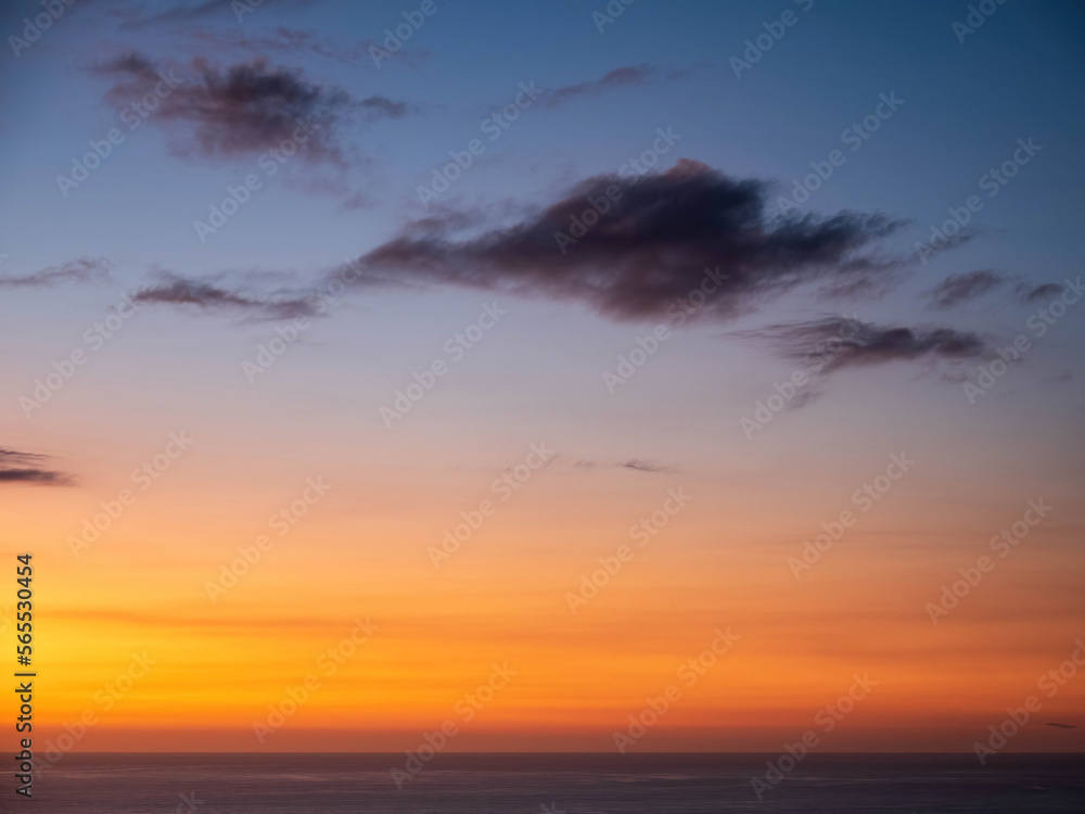 Sunset clouds over Tasma sea at Piha Beach, Auckland