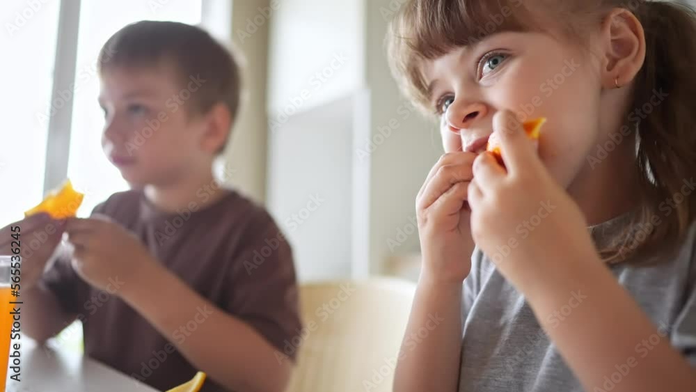 children eat oranges. happy family a kid dream concept. drinking fresh juices. morning breakfast brother and sister eat oranges in the kitchen. fruits fun orange juice healthy eating children eat oranges. happy family a kid dream concept. drinking fresh juices. morning breakfast brother and sister eat oranges in the kitchen. fruits fun orange juice healthy eating