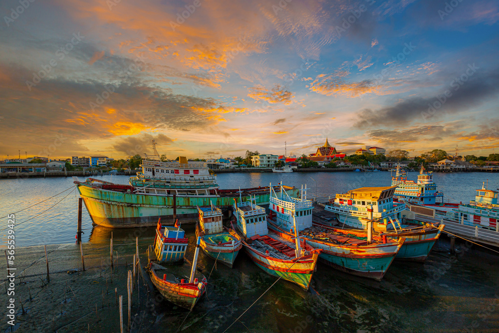 evening view of fishing boat marina in thailand,Group of fishing boats docked at the Port of river in fisherman village in Pak nam,Rayong,Thailand.