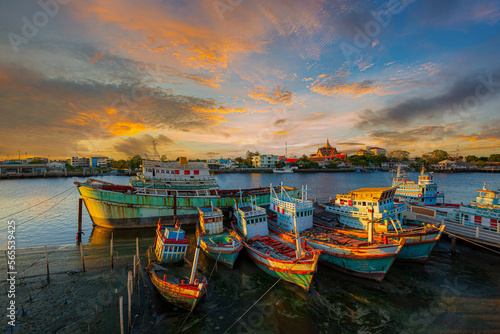 evening view of fishing boat marina in thailand,Group of fishing boats docked at the Port of river in fisherman village in Pak nam,Rayong,Thailand.