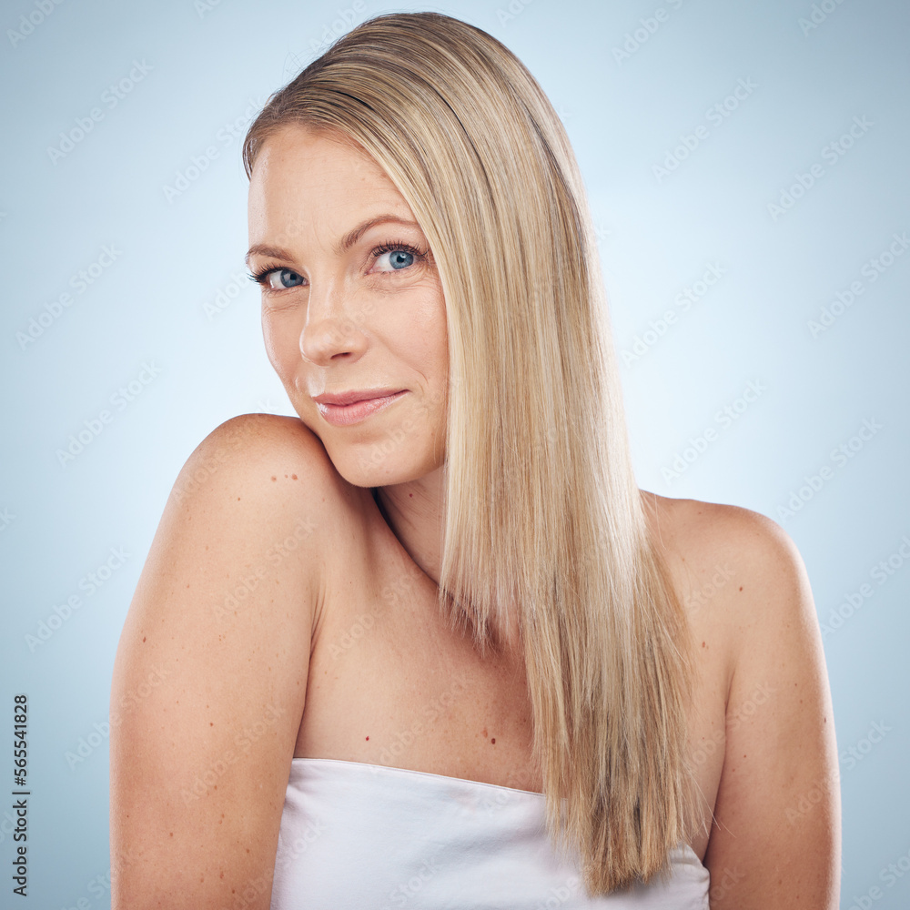 Obraz premium Skincare, beauty and portrait of a woman with hair care isolated on a blue background in a studio. Spa, wellness and cosmetology model with facial makeup, cosmetics and dermatology on a backdrop