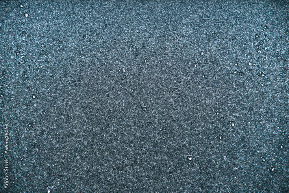 Macro of car glass window covered with ice and snow. Concept of bad visibility during freezing weather conditions.