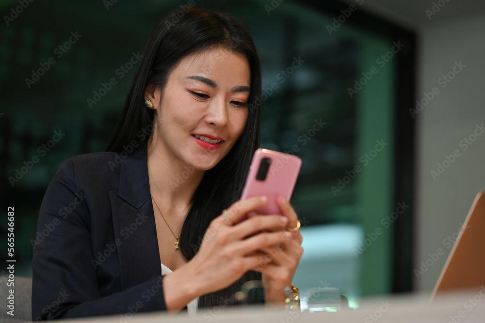 Close up with Mature Businesswoman with casual suit outfit using smartphone. Close up with Mature Businesswoman with casual suit outfit using smartphone.
