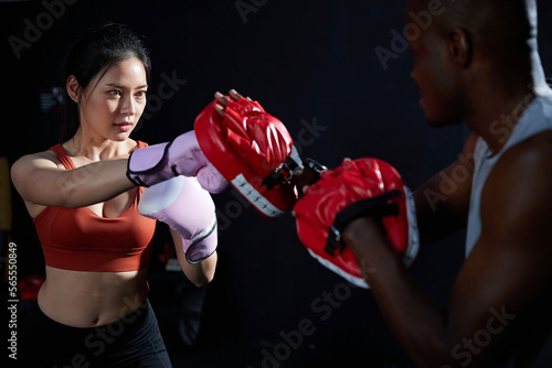 sportswoman or fighter training boxing in the gym
